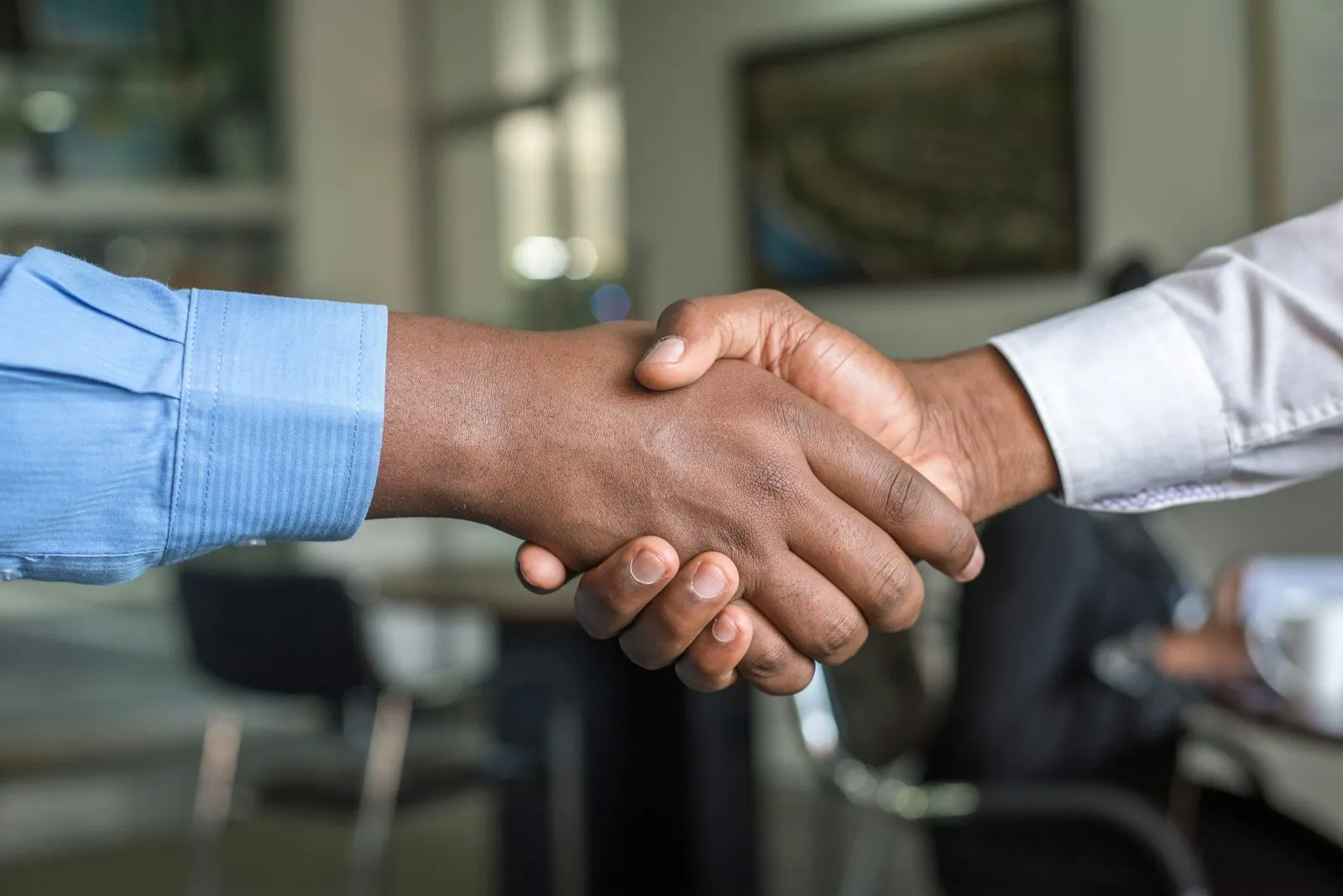 Professionals shaking hands to begin a health and safety consulting engagement