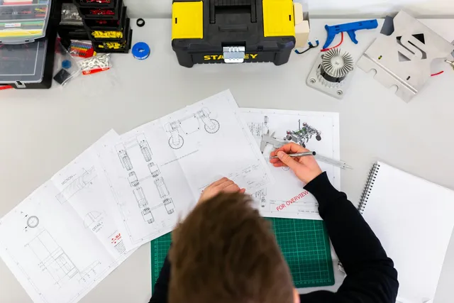 Safety professional preparing a task-based risk assessment with technical drawings