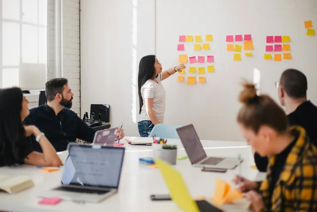 Consulting team planning a SHEQ management system on a project board